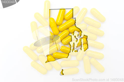 Image of Outline map of rhode island with transparent pills in the backgr