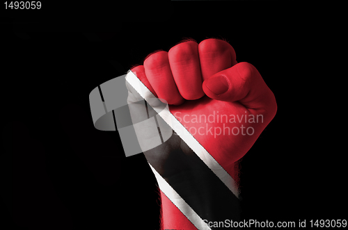 Image of Fist painted in colors of trinidad tobago flag