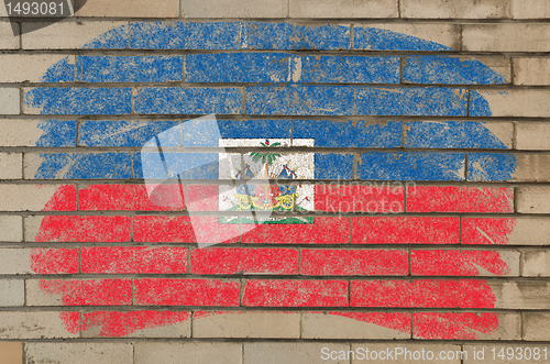 Image of flag of Haiti on grunge brick wall painted with chalk  
