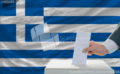 Image of man voting on elections in greece