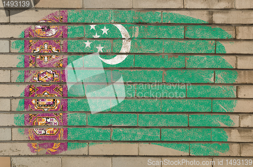 Image of flag of turkmenistan on grunge brick wall painted with chalk  