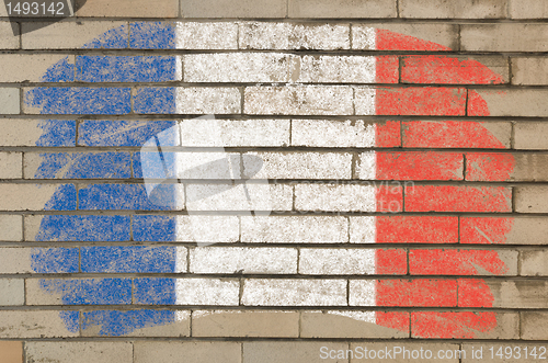 Image of flag of France on grunge brick wall painted with chalk  