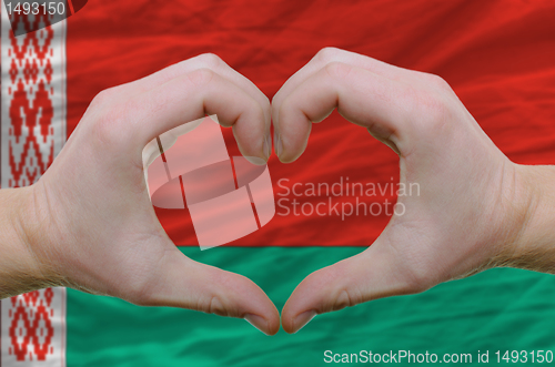 Image of Heart and love gesture showed by hands over flag of belarus back