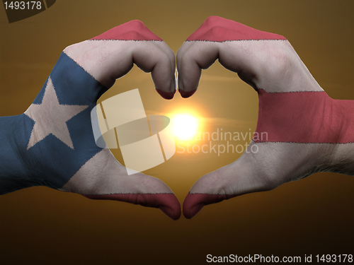 Image of Heart and love gesture by hands colored in puertorico flag durin