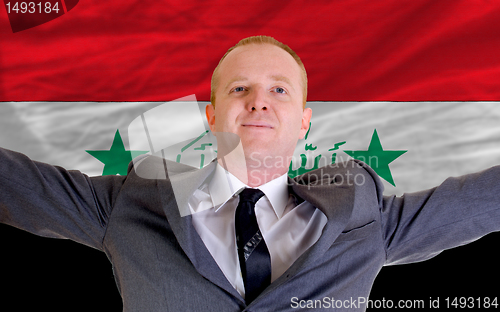 Image of happy businessman because of profitable investment in iraq stand