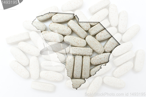 Image of Outline map of south carolina with transparent pills in the back