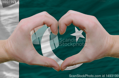 Image of Heart and love gesture showed by hands over flag of pakistan bac