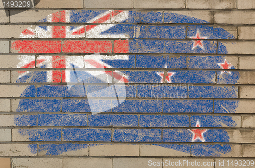 Image of flag of New Zealand on grunge brick wall painted with chalk  