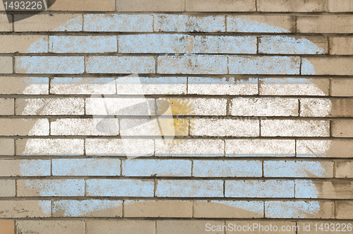 Image of flag of Argentina on grunge brick wall painted with chalk  