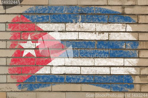 Image of flag of Cuba on grunge brick wall painted with chalk  