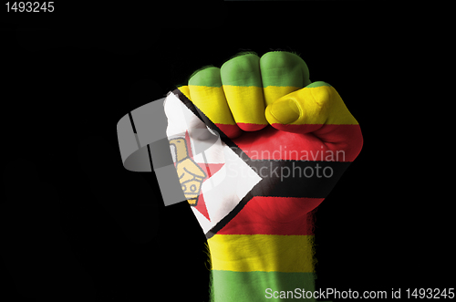 Image of Fist painted in colors of zimbabwe flag