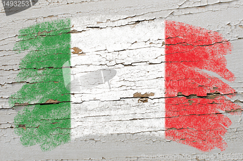 Image of flag of Italy on grunge wooden texture painted with chalk  