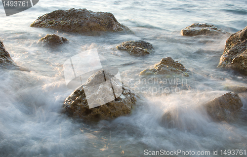 Image of stones in sea water washing by waves