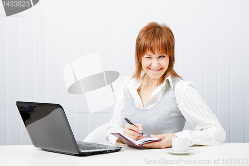 Image of smiling attractive girl with a notebook. Office worker