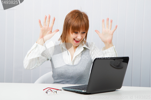 Image of Delighted girl looks at a monitor