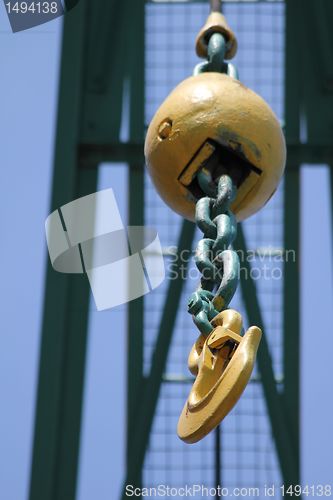 Image of old yellow crane hook