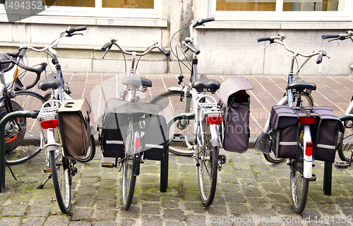 Image of Bicycles standing in parking place with boxes.