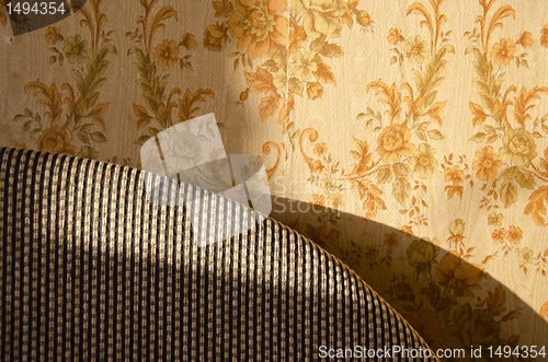 Image of Old home interior design. Bed fragment and wall.