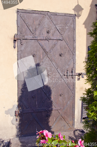 Image of Ancient metal door with locked padlock ornament.