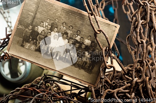 Image of Sad children in a photo surrounded with chains