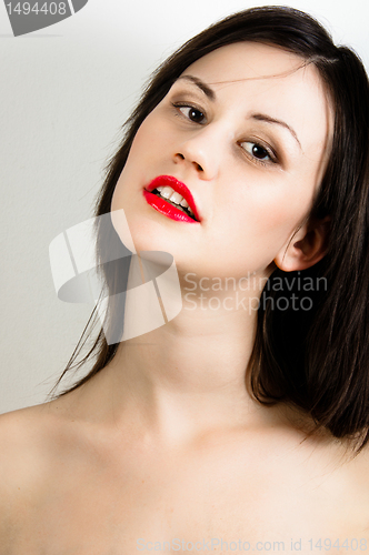 Image of oung fashion model with white skin and red lipstick