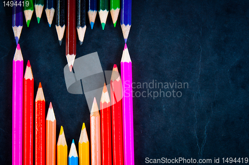 Image of Colorful pencils on dark background in a shape of a heart