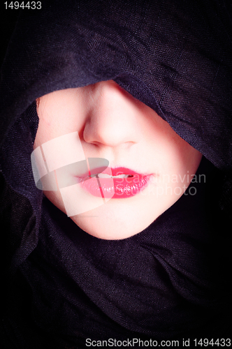 Image of Part of a woman's face with black hood