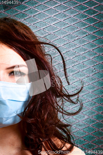 Image of A girl in a protective mask against white isolated background