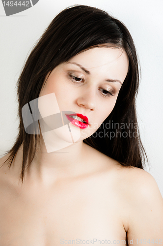 Image of oung fashion model with white skin and red lipstick