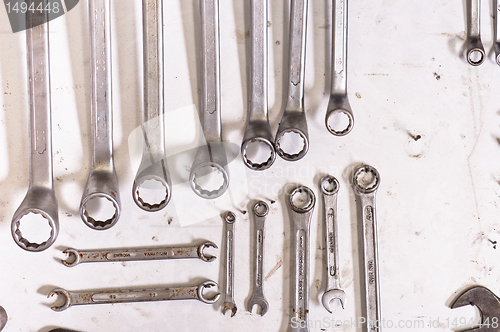 Image of Industrial spanners on white board hanging