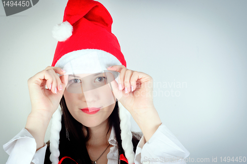 Image of Girl in Santa's hat against white background