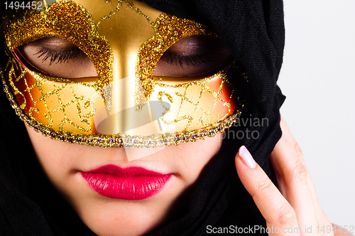 Image of Carnival mask on a young attractive girl against white backgroun