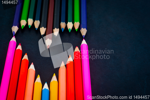 Image of Colorful pencils on dark background in a shape of a heart