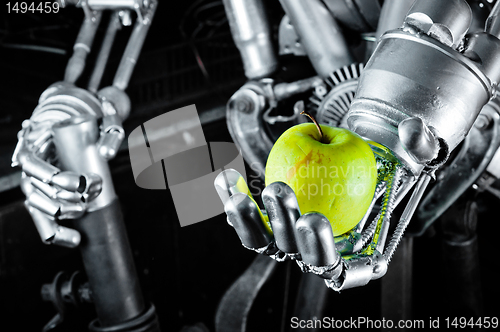 Image of Green apple in the hands of a robot