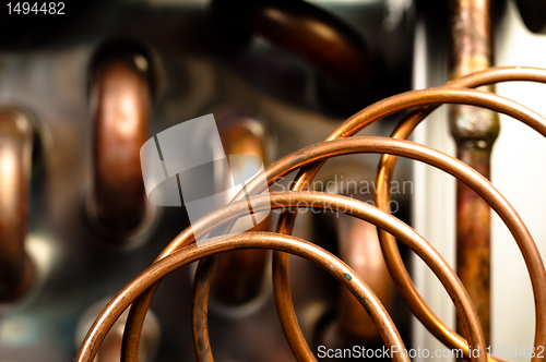 Image of Close up of orange wires and pipes