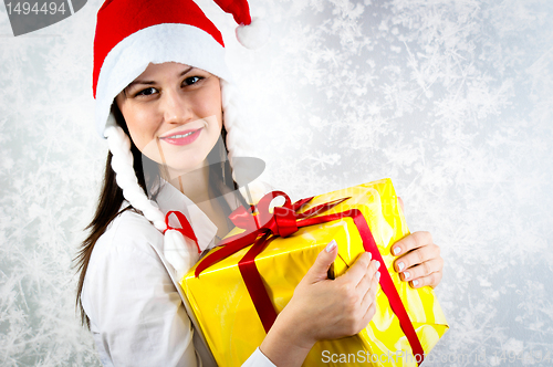 Image of Young girl with joyful expression holding her present