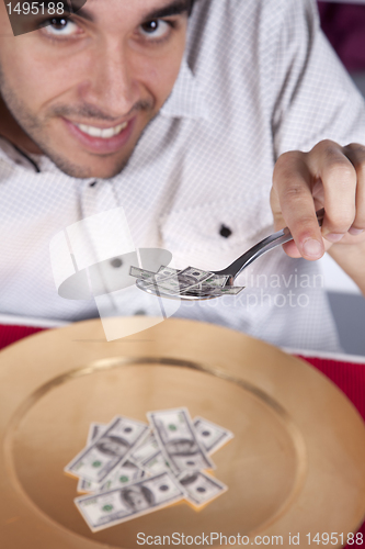 Image of Man eating little dollar banknote