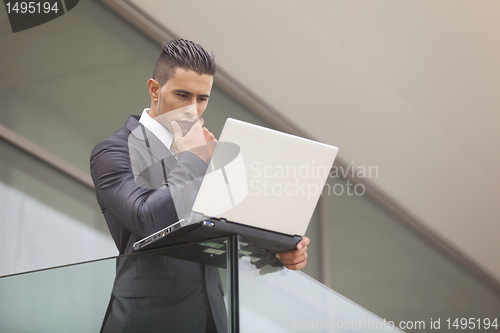 Image of Modern businessman at the office balcony