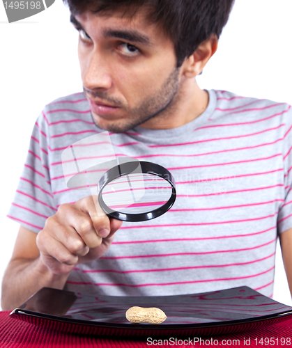 Image of Man looking to a peanut