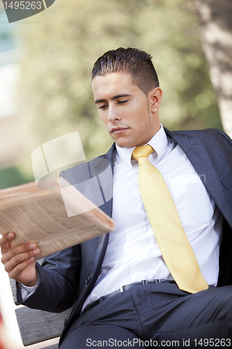 Image of Businessman reading the newspaper