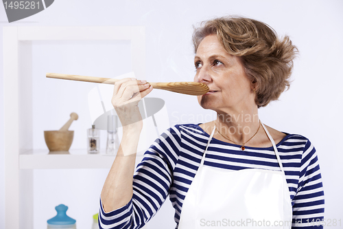 Image of Senior woman tasting food