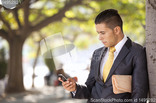 Image of Businessman sending messages at the cellular