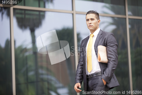 Image of Businessman walking next to his office