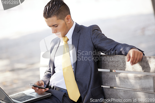 Image of Businessman working at the city park