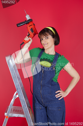 Image of Stressed woman holding a electric drill