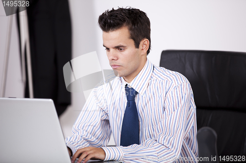 Image of Businessman working at his laptop