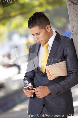 Image of Businessman sending messages at the cellular