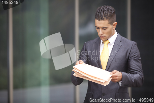 Image of Businessman walking next to his office