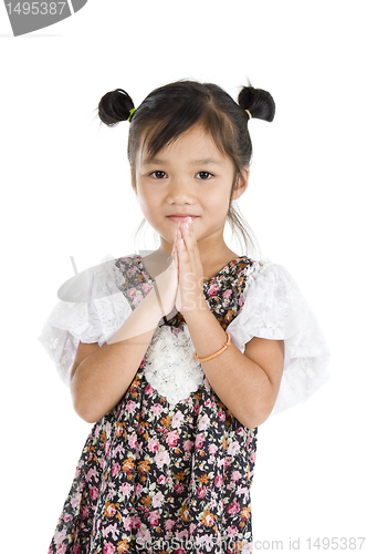 Image of cute Asian girl with folded hands