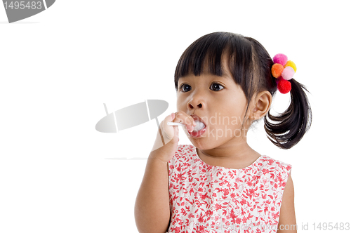 Image of cute little girl with a lollipop